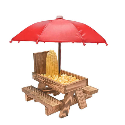 Mini wooden feeding table with red umbrella for squirrels and birds, featuring corn kernels and drainage design.