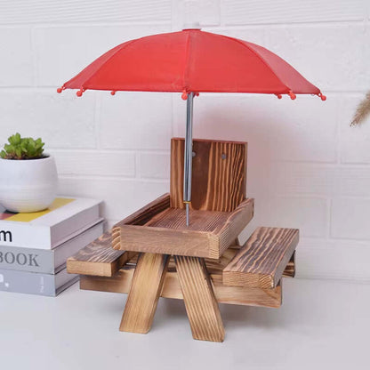 Mini wooden feeding table with red umbrella for squirrels and birds, designed for safe and easy use.